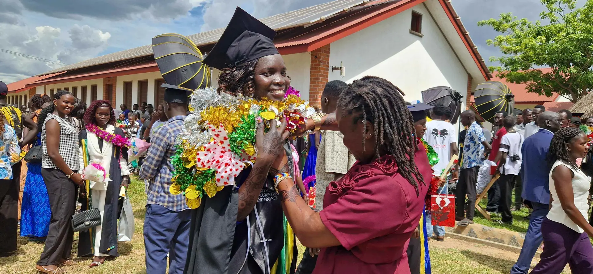 A new graduate is congratulated with flowers
